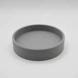 Round key tray styled on entryway console with keys and small objects inside