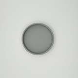 Close detail of round key tray surface showing minimalist geometric form
