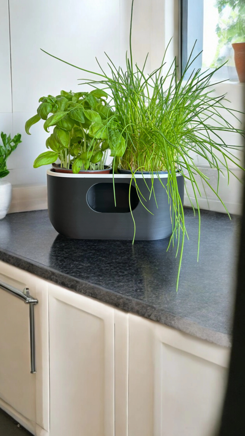 Oval self-watering planter in white, showing clean minimalist profile