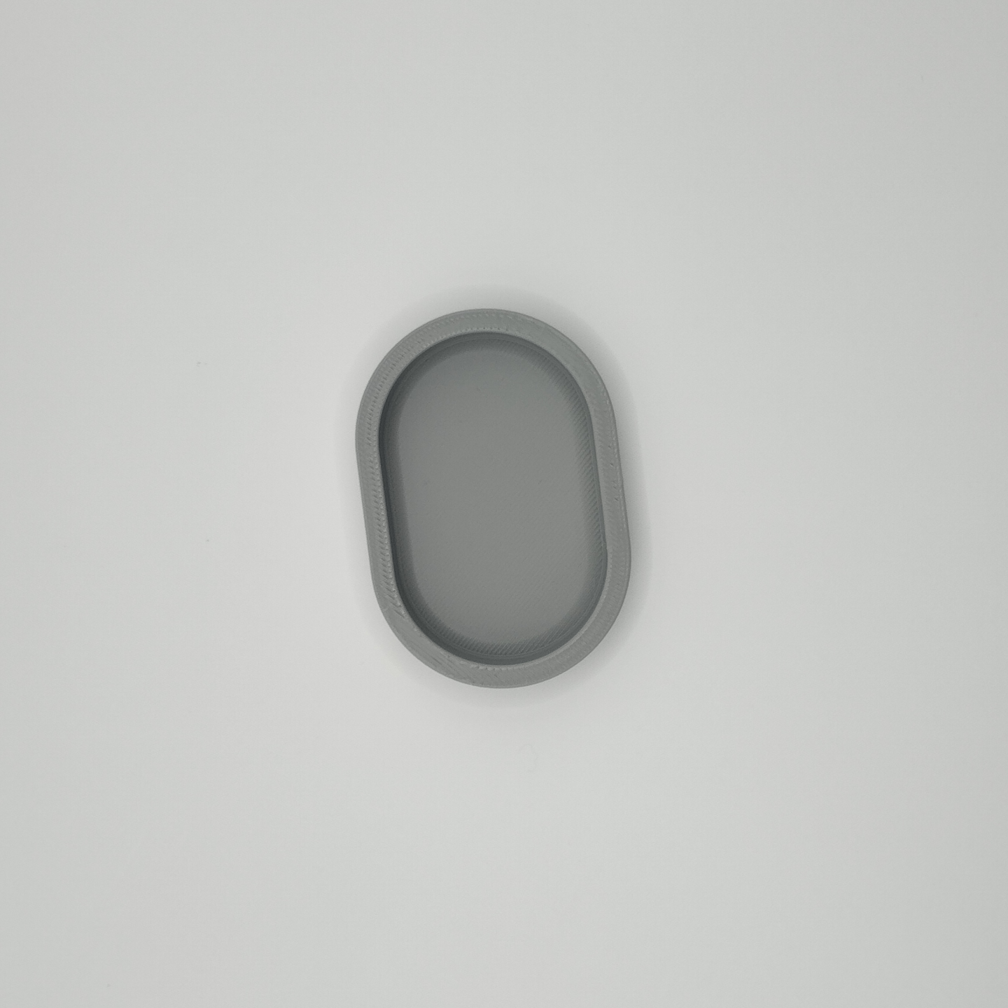 Smooth curved edge of rounded key tray showing soft sculptural form