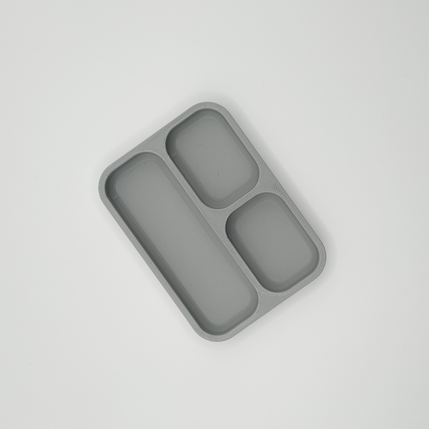 Detail of geometric lines on minimalist key and coin tray surface