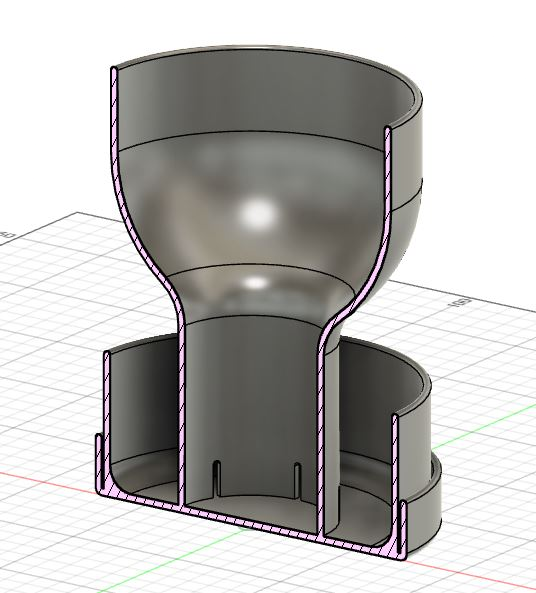 Grail-shaped self-watering planter on a minimalist shelf with indoor plant