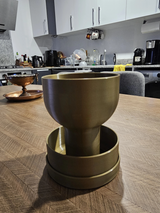 Self-watering planter with grail design, close-up view of elegant silhouette