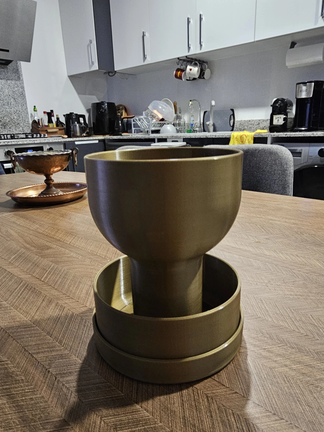 Self-watering planter with grail design, close-up view of elegant silhouette