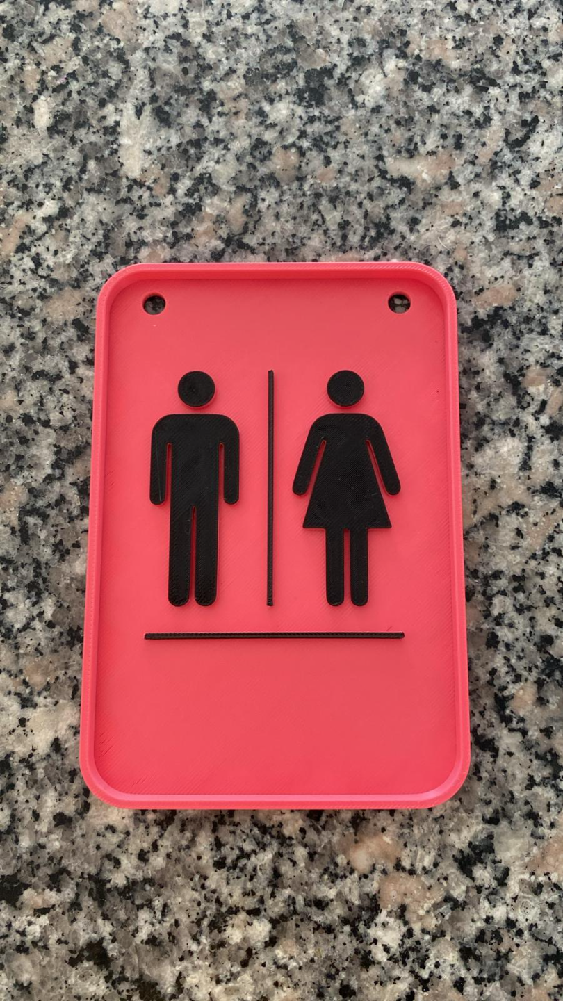 Minimalist toilet door sign with clean lettering, close-up view