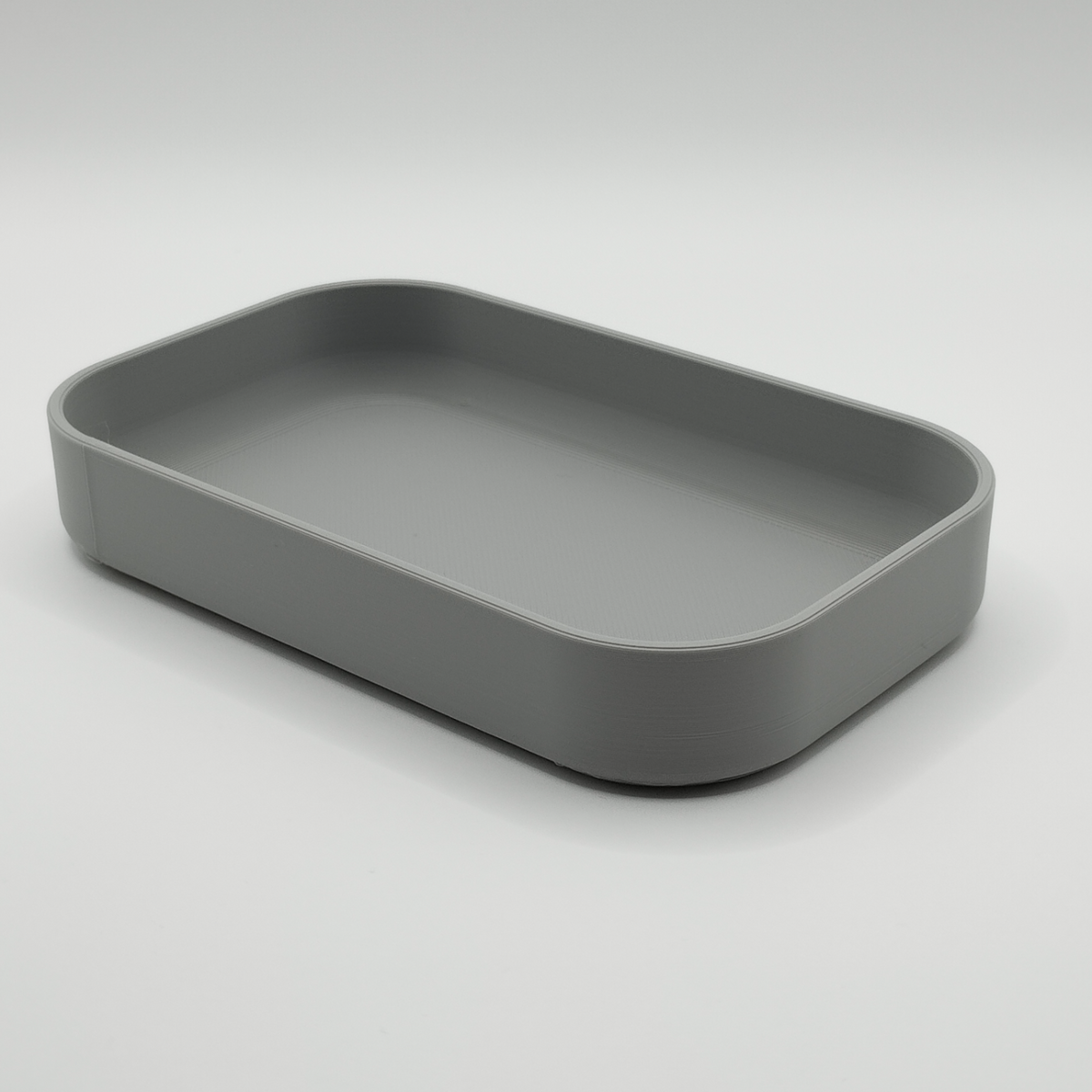 Rectangular key tray styled on entryway console with keys and coins inside