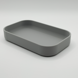 Rectangular key tray styled on entryway console with keys and coins inside