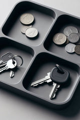 Top view of a four-compartment key tray with minimalist design