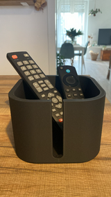 Remote holder styled on a living room side table with coffee mug and plant