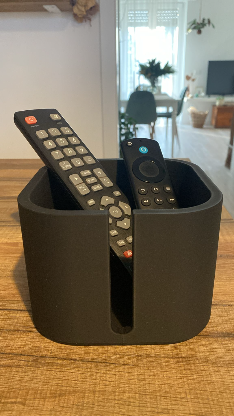 Remote holder styled on a living room side table with coffee mug and plant