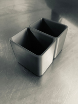 Modern toothbrush holder on bathroom counter next to sink