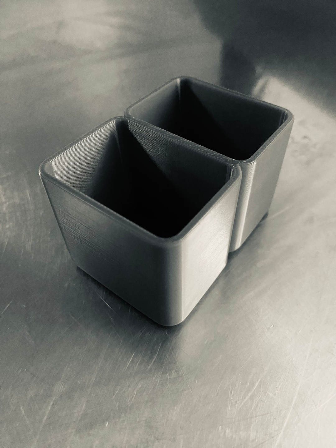 Modern toothbrush holder on bathroom counter next to sink