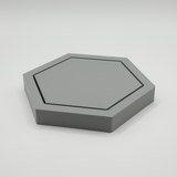Hexagonal coaster placed on wooden table with coffee cup, minimalist table setting