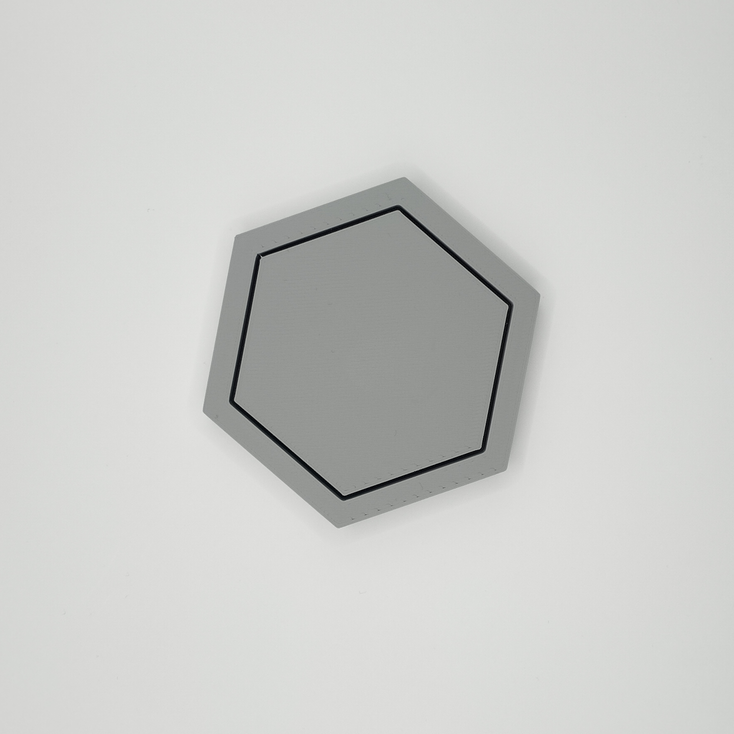 Close-up detail of hexagonal coaster edge, showing clean geometry and finish