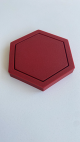 Hexagonal coaster photographed from above, showing geometric shape and flat surface