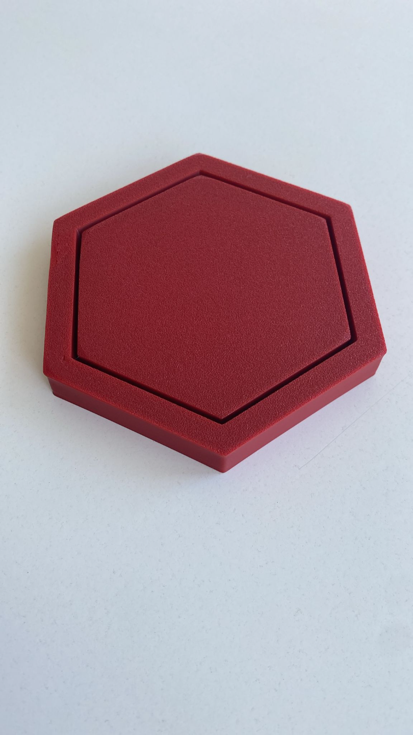 Hexagonal coaster photographed from above, showing geometric shape and flat surface