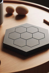 Four hexagonal minimalist coasters arranged in a group, clean geometric form