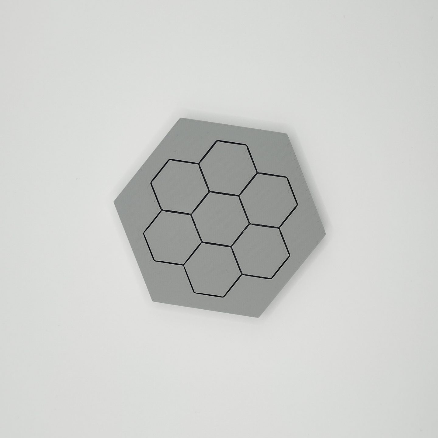 Close-up detail of hexagonal coaster edge and flat surface texture