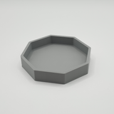 Octagonal key tray on entryway console with keys and wallet
