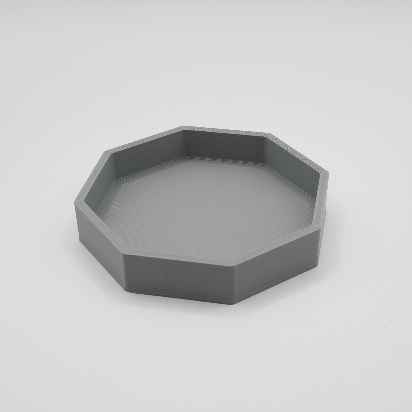Octagonal key tray on entryway console with keys and wallet