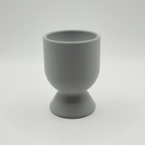 Modern egg cup on a natural linen napkin with soft morning light