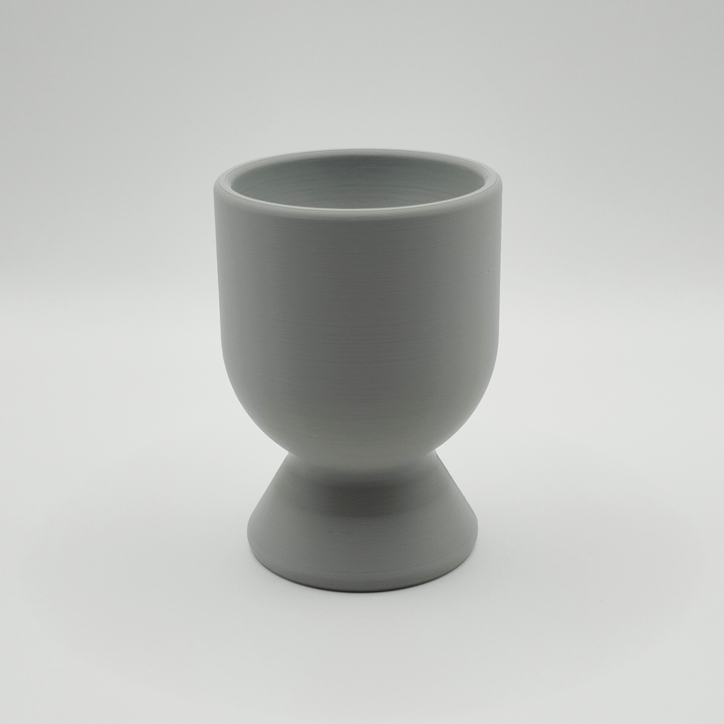 Modern egg cup on a natural linen napkin with soft morning light