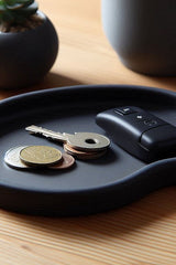 Close-up of kidney flush key tray showing organic curved form and smooth surface