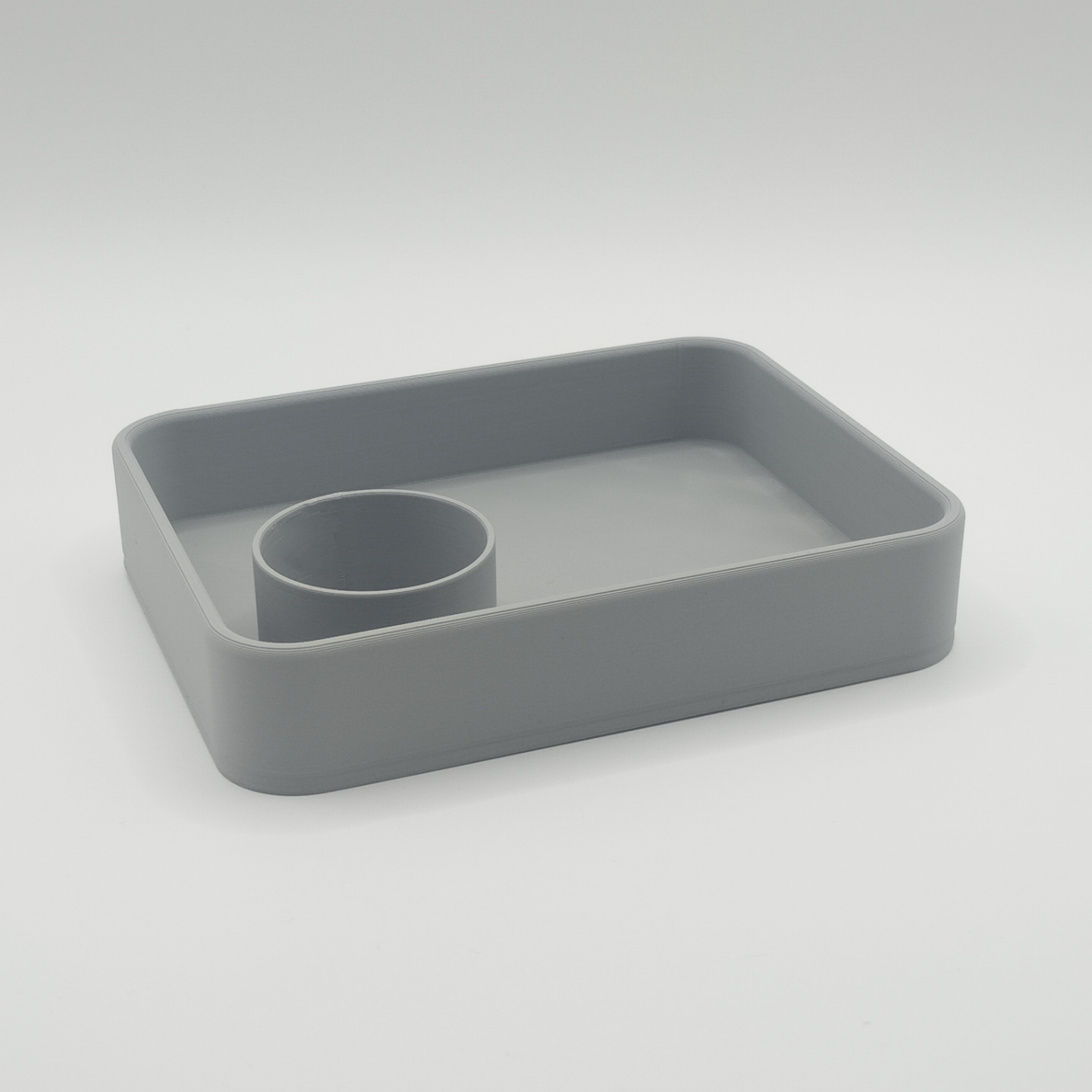 Key and coin tray styled on a light wood desk with keys inside