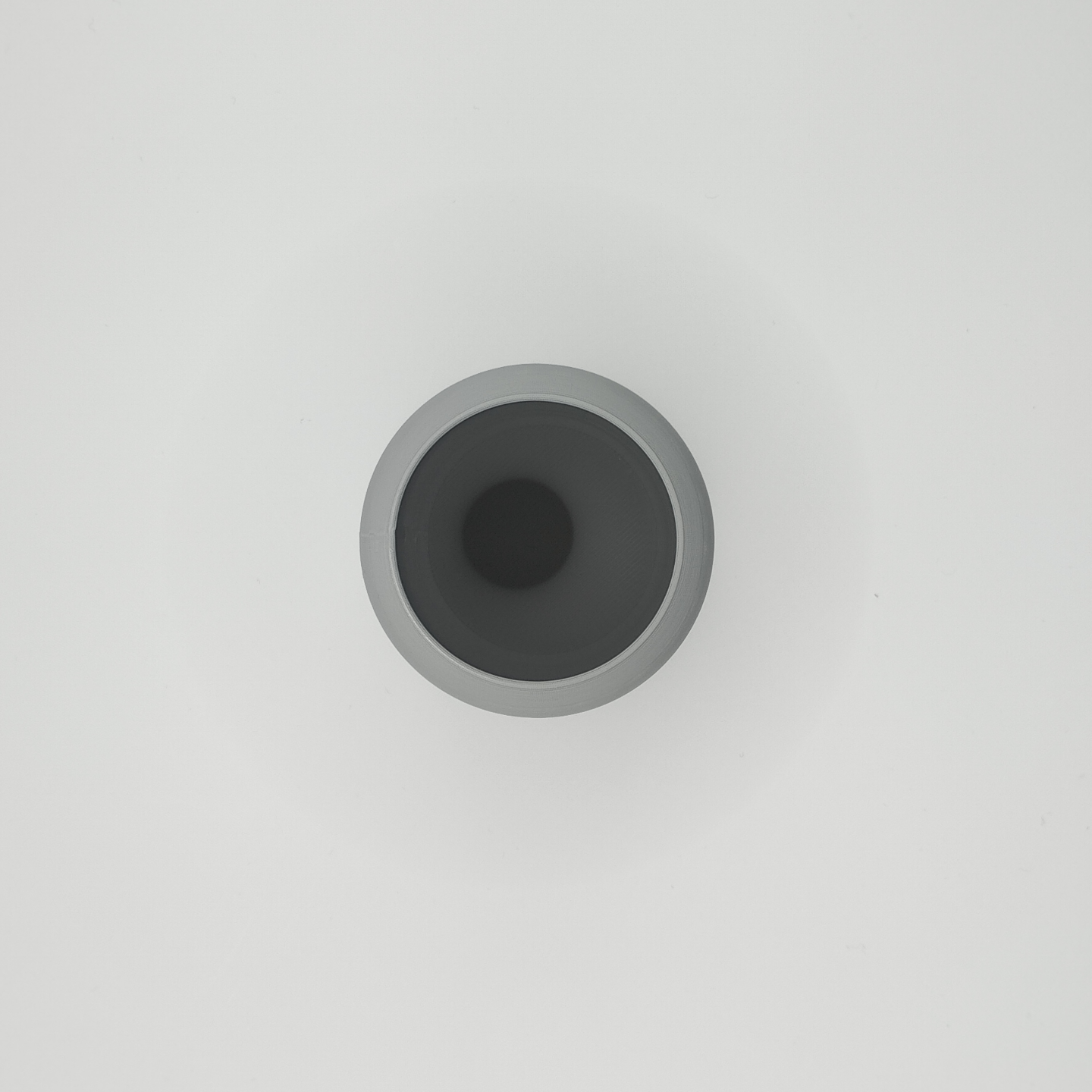 Close-up of the smooth curved rim of a rounded toothbrush holder