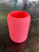 White rounded toothbrush holder with toothbrush and paste tube inside
