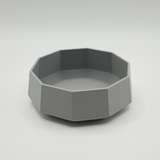 Minimalist bowl displayed on a light shelf with natural decor styling