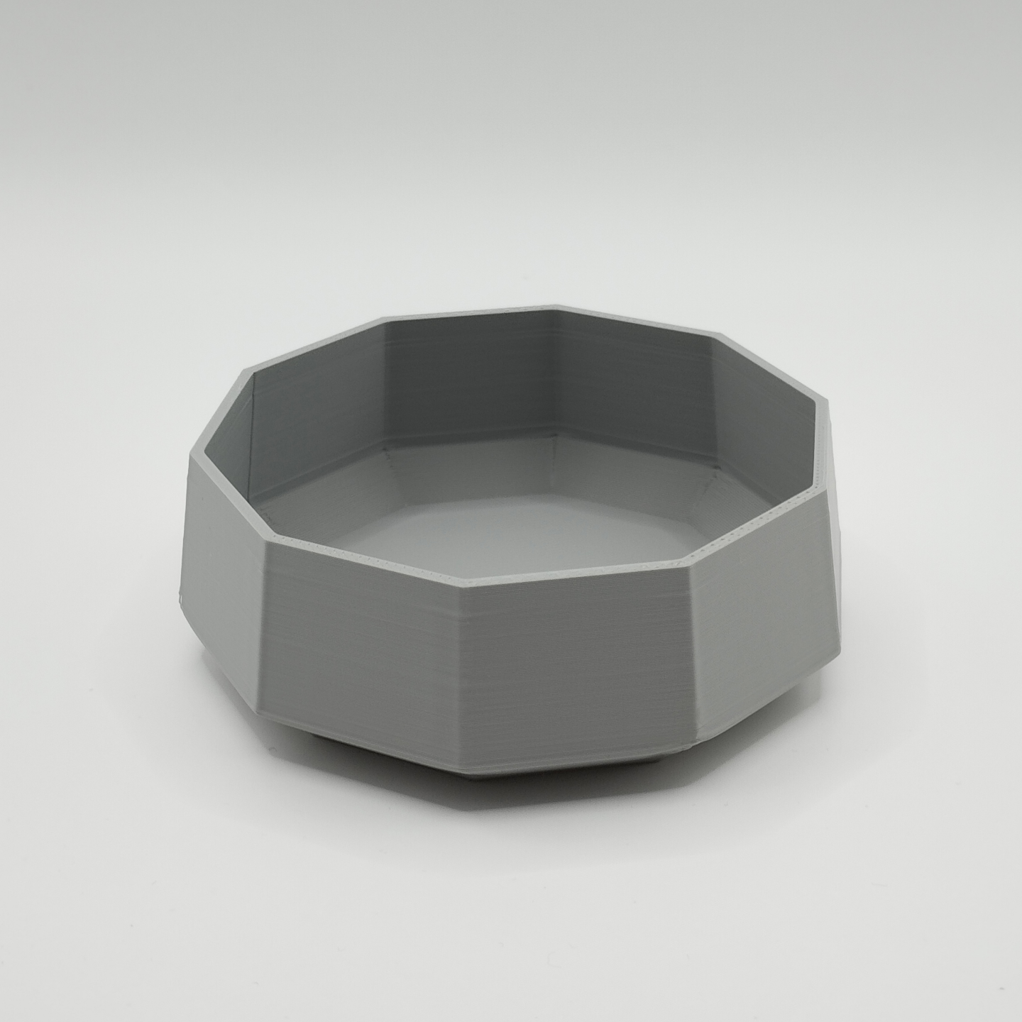Minimalist bowl displayed on a light shelf with natural decor styling