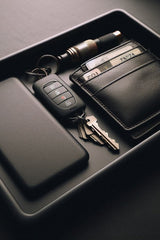 Minimalist key tray with recessed edges, holding keys and coins