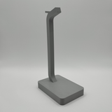 Modern headphone stand with headphones resting on desk workspace