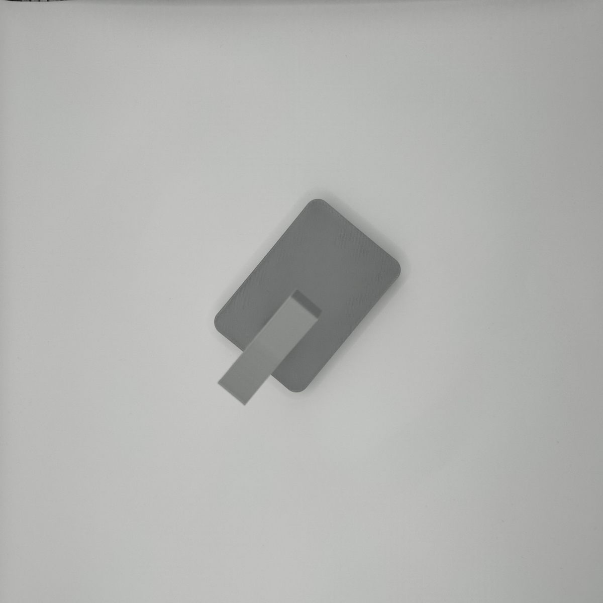 Detail of headphone stand's angular support structure and neutral finish