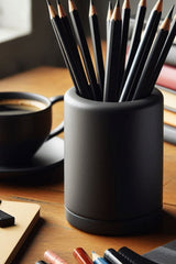 Round pencil holder with clean cylindrical form, shown from above with various pens inside