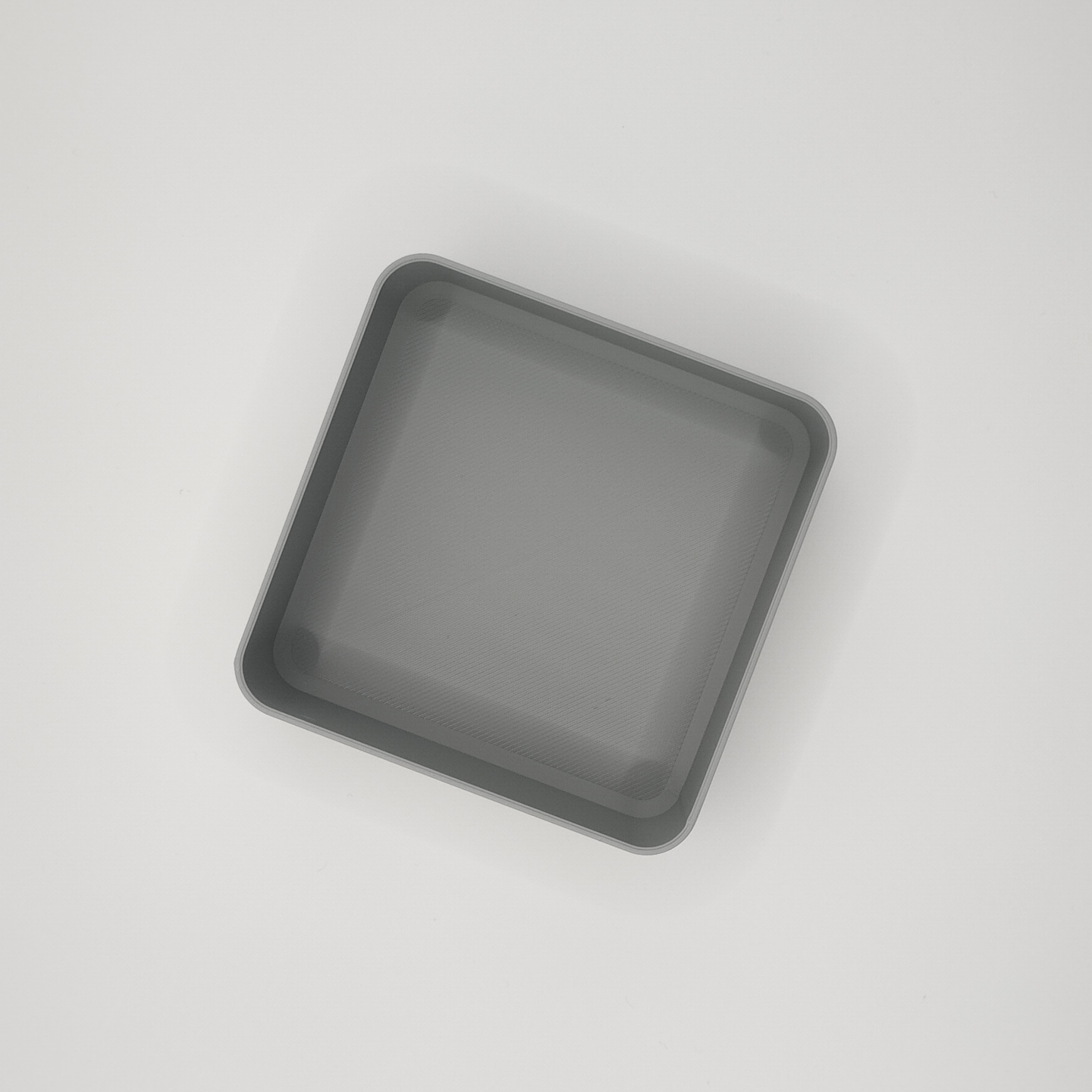 Detail of the shallow interior surface of the minimalist square catch-all bowl