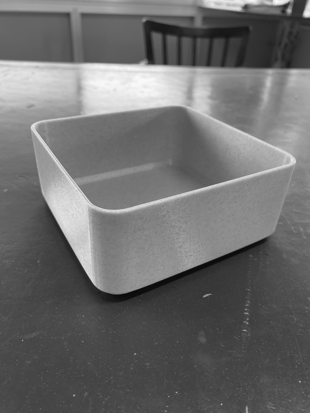 Close-up of minimalist square bowl showing clean geometric edges and matte finish