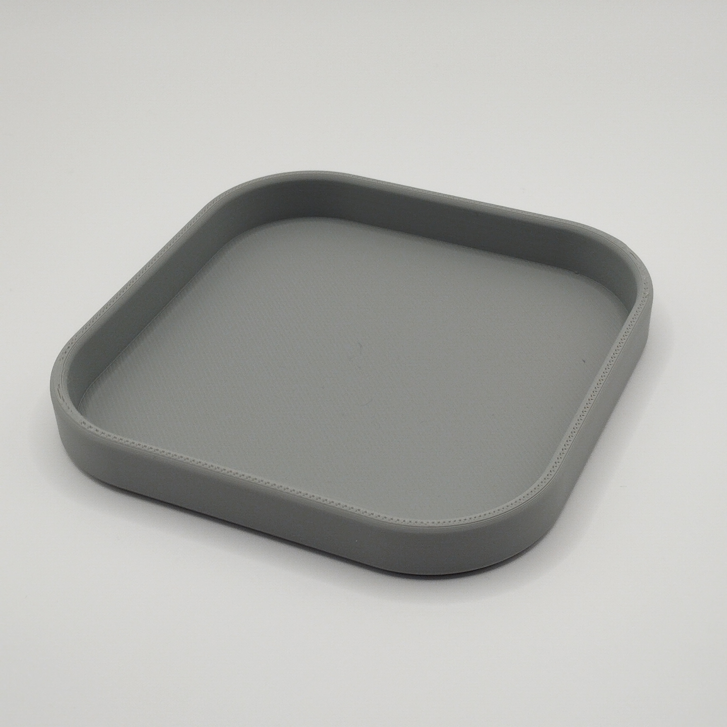 Close-up detail of the square key and phone tray's crisp edge and smooth finish