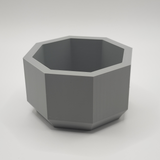 Detail of the eight-sided edge of the minimalist planter catching soft light