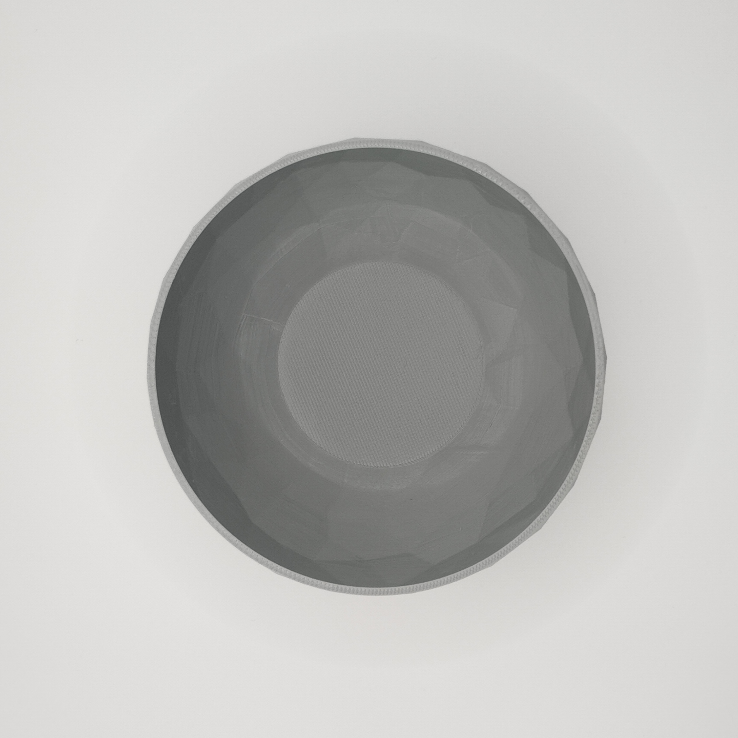 Detail of the sculptural faceted texture on the low poly bowl surface