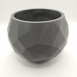 Low poly bowl styled on white shelf with minimal home decor in soft Nordic interior