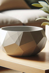Close-up of geometric diamond bowl showing pressed facet design and smooth finish