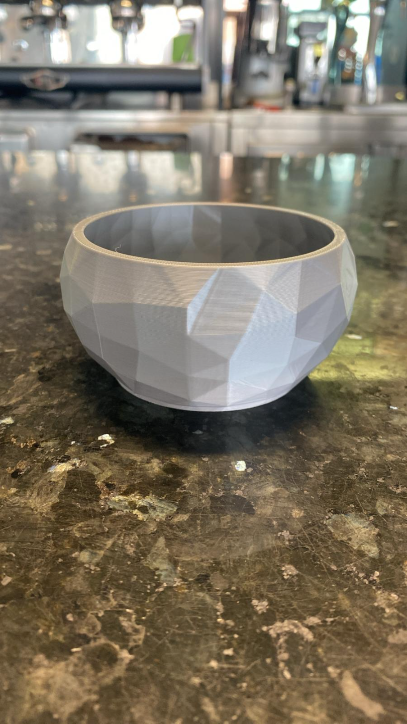 Detail of angular faceted surface on minimalist diamond bowl catching light