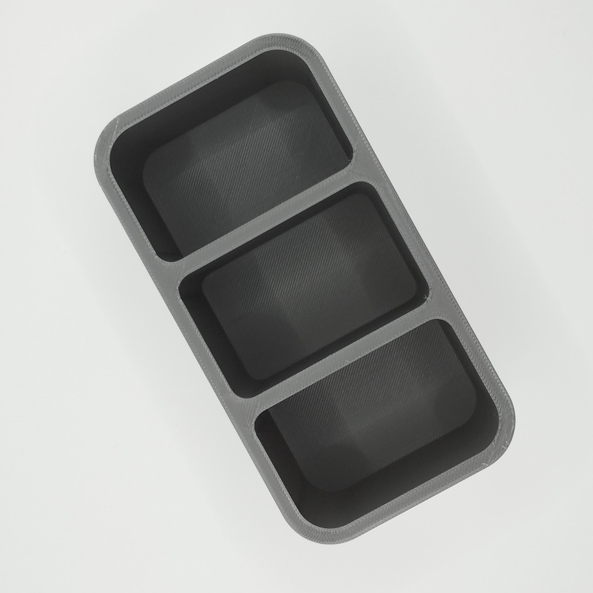 Close detail of the remote holder's smooth, simple form