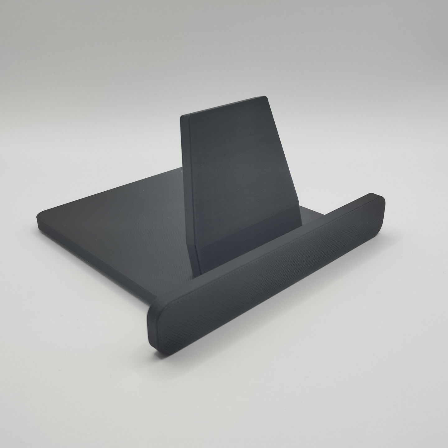 iPad tablet stand on wooden desk with phone resting at viewing angle