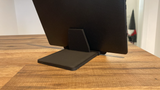 Minimalist tablet stand in white, side view showing geometric form and angle