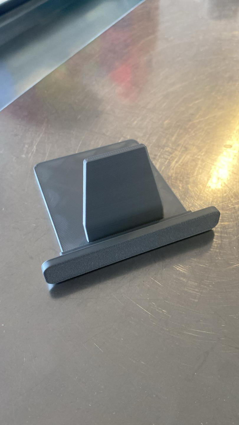 Minimalist tablet stand in white, side view showing geometric form and angle