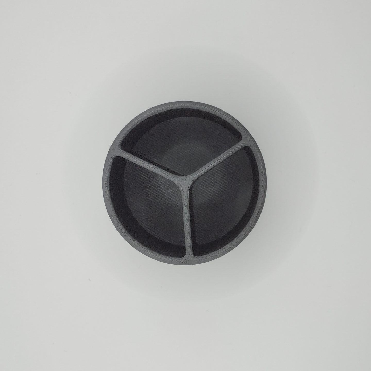 Close detail of the smooth surface and open rim of the minimalist brush container