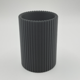 Ribbed pencil holder on desk with pens and minimal workspace styling